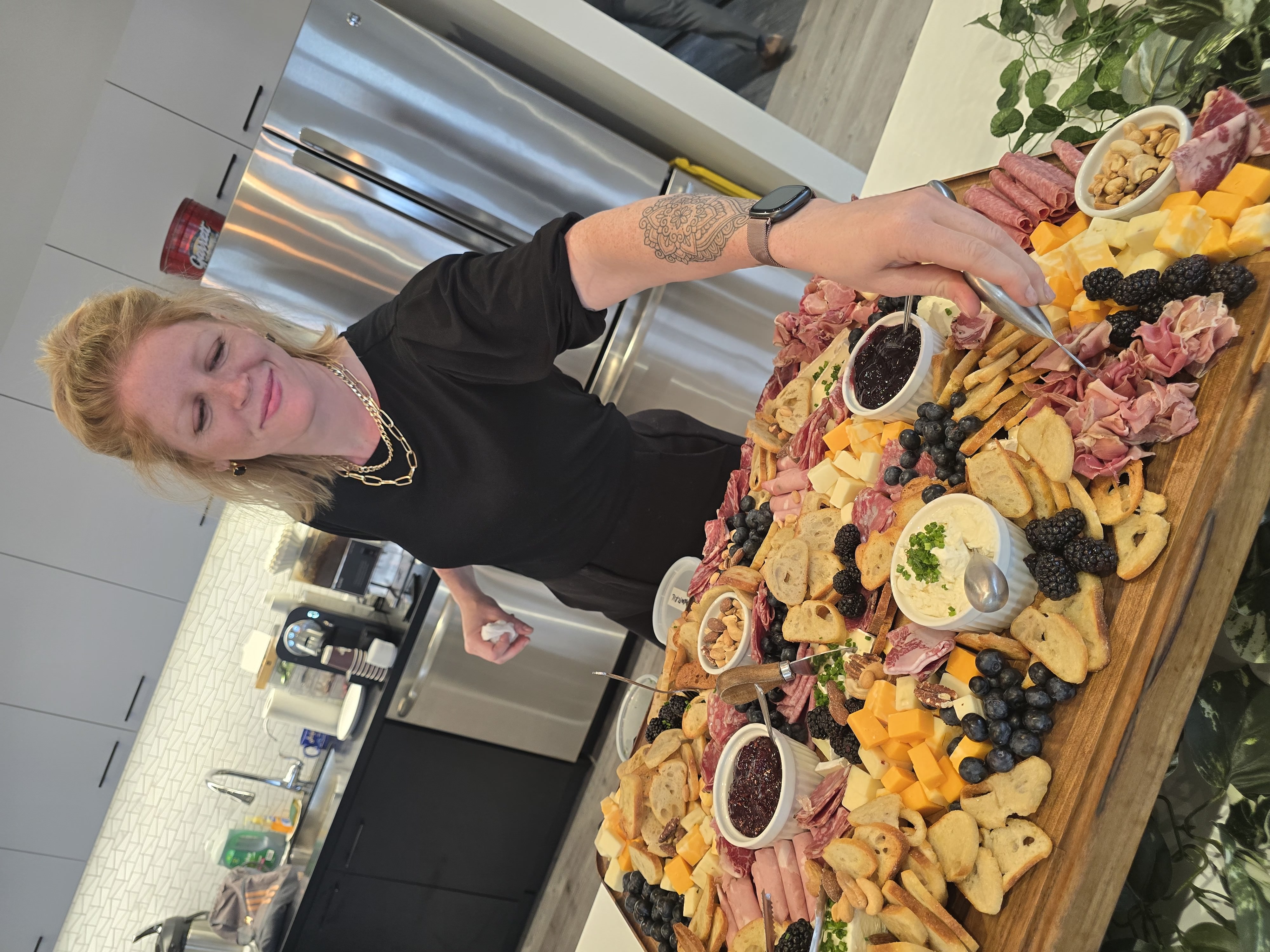 Jesse preparing an elaborate charcuterie board for a private event